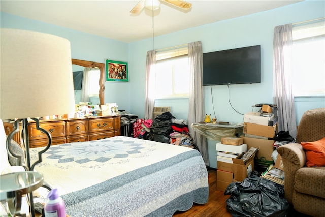 bedroom featuring a ceiling fan and dark wood finished floors