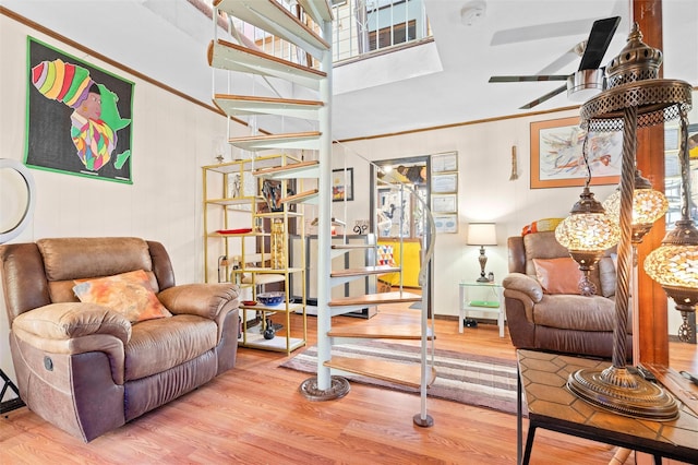 sitting room featuring a ceiling fan and wood finished floors