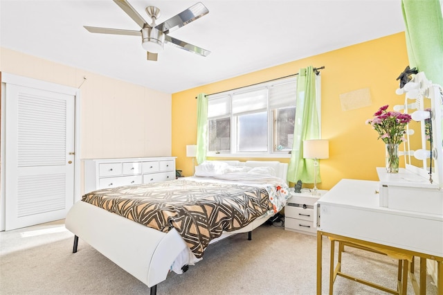 bedroom featuring light carpet and ceiling fan