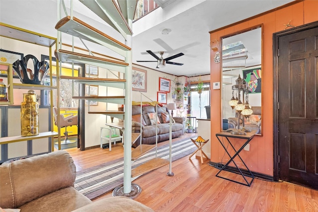 living area with ceiling fan and light wood finished floors