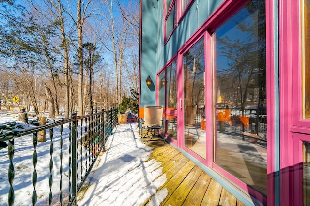 view of snow covered back of property