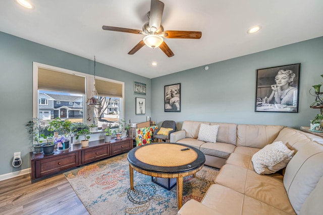 living room with light wood-style flooring, baseboards, a ceiling fan, and recessed lighting