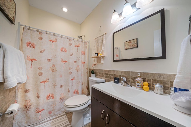 full bath featuring tile walls, vanity, and toilet