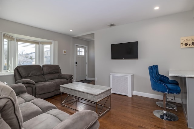 living room with recessed lighting, visible vents, dark wood finished floors, and baseboards