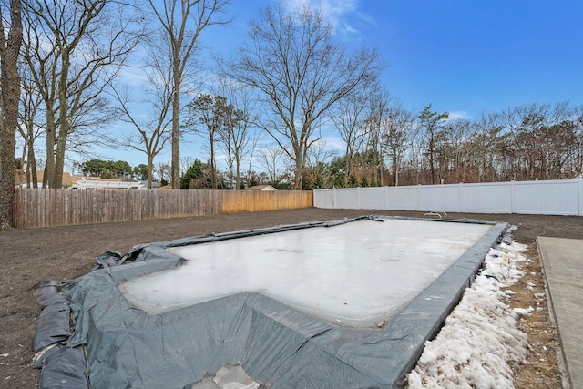 view of pool with a fenced backyard