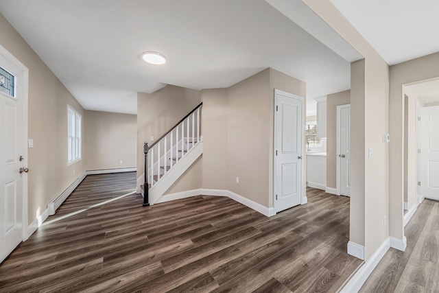 entrance foyer featuring dark wood-style floors, a baseboard radiator, stairs, and baseboards