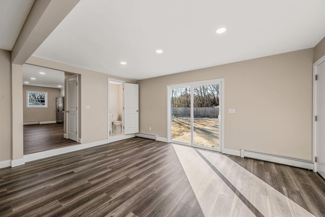 interior space with baseboard heating and dark wood-style flooring