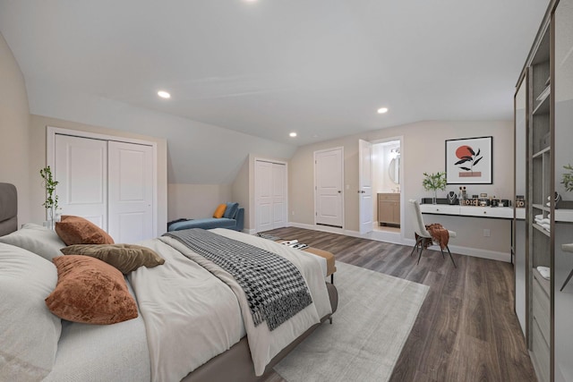 bedroom featuring lofted ceiling, recessed lighting, wood finished floors, and multiple closets