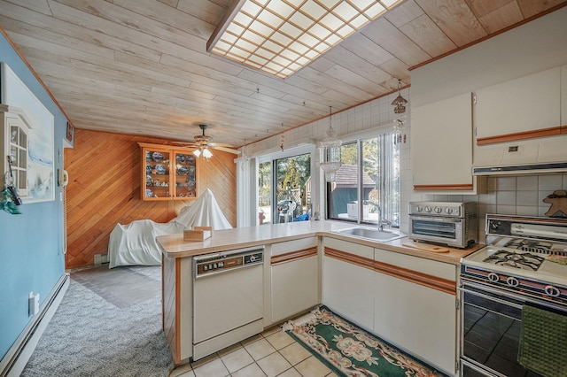 kitchen with wood ceiling, a sink, gas range, dishwasher, and a peninsula