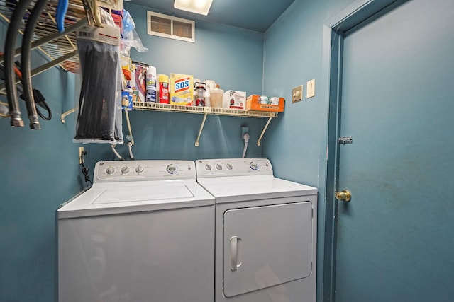 laundry area featuring laundry area, visible vents, and separate washer and dryer