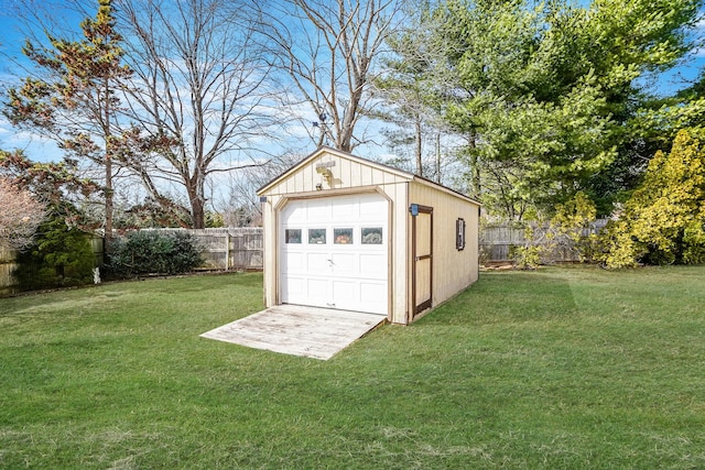 detached garage with driveway and fence