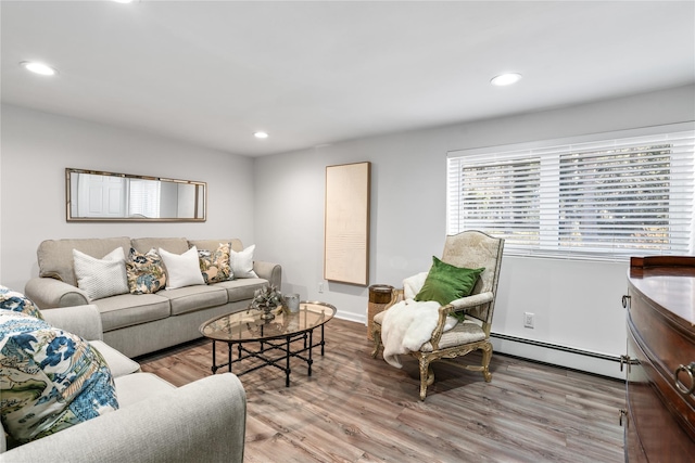 living room with a baseboard radiator, recessed lighting, and wood finished floors