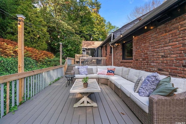 wooden terrace featuring an outdoor living space