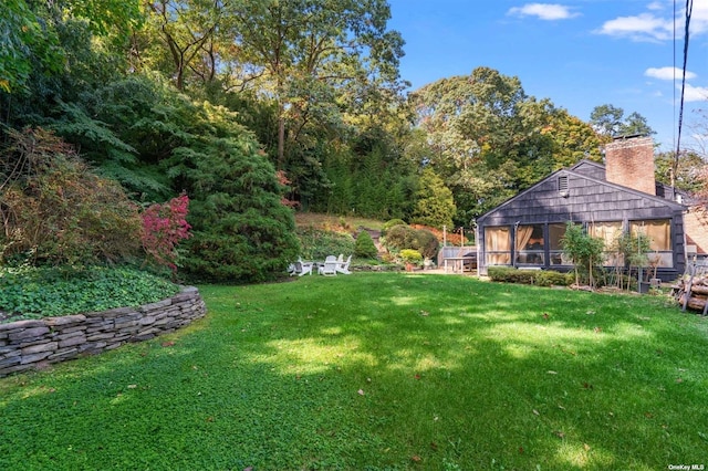 view of yard with a sunroom