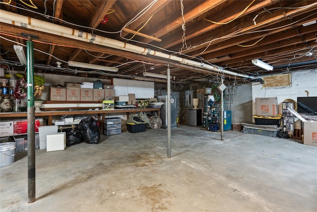 unfinished basement with refrigerator and electric panel