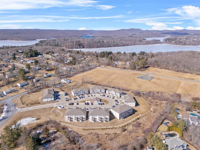 aerial view featuring a water view and a wooded view