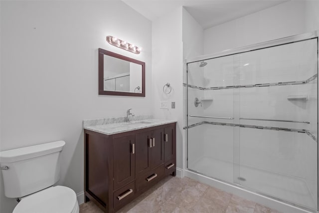 bathroom with toilet, a stall shower, and vanity