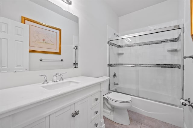 full bathroom with toilet, shower / bath combination with glass door, tile patterned flooring, and vanity