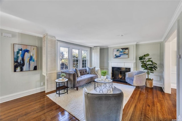 living room featuring ornamental molding, wood finished floors, a fireplace with flush hearth, and baseboards