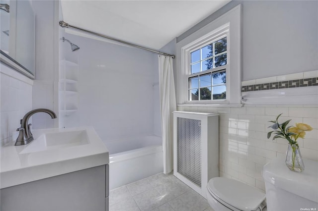 bathroom with tile walls, shower / bathtub combination with curtain, toilet, vanity, and tile patterned flooring