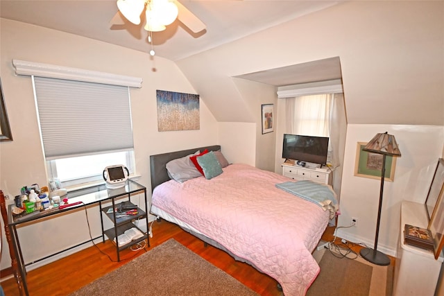 bedroom with lofted ceiling, wood finished floors, and a ceiling fan