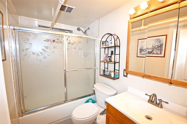 full bathroom with toilet, bath / shower combo with glass door, vanity, and visible vents