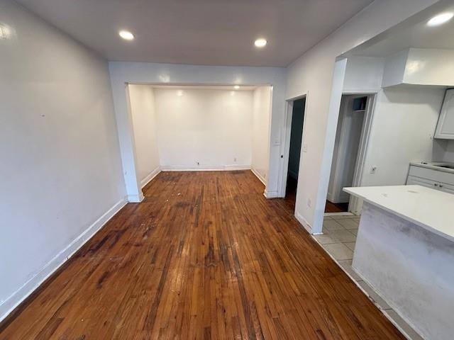 interior space featuring light wood-type flooring, baseboards, and recessed lighting