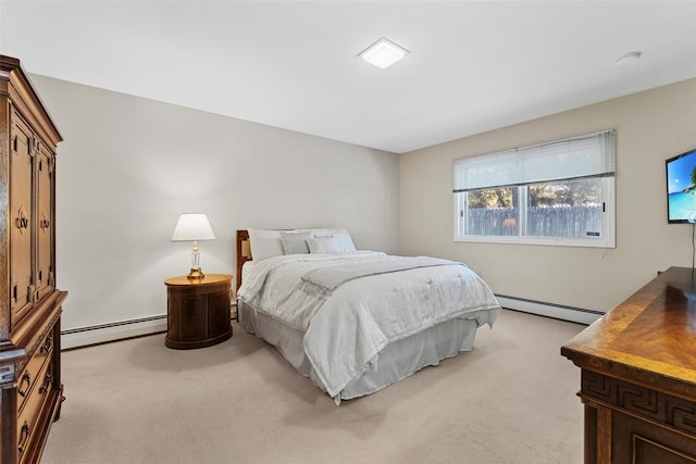 bedroom with a baseboard heating unit and light colored carpet