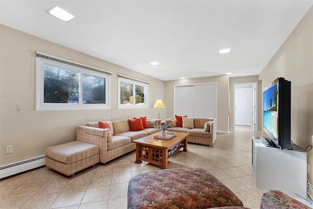 living room with baseboards, baseboard heating, and light tile patterned floors