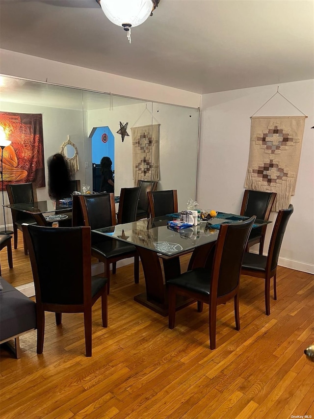 dining space featuring baseboards and wood finished floors