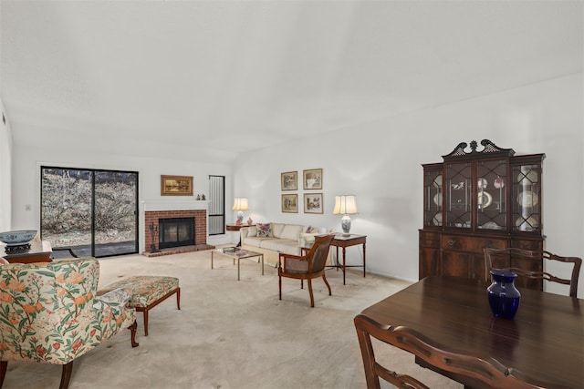 carpeted living room featuring a brick fireplace