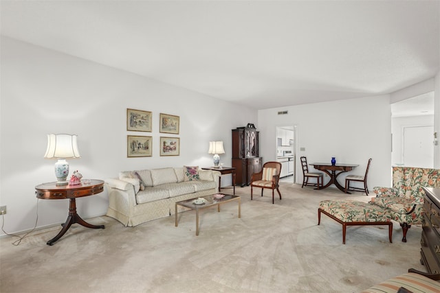 living area featuring visible vents and carpet flooring