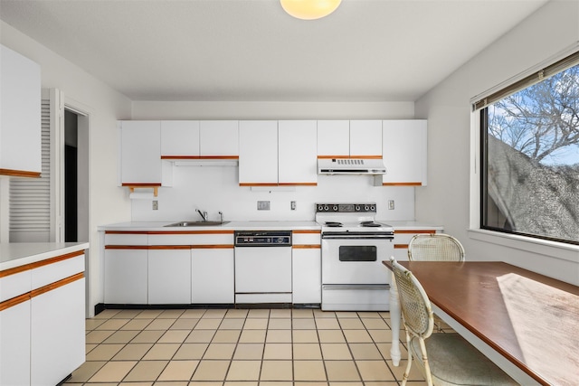 kitchen featuring white appliances, light countertops, under cabinet range hood, white cabinetry, and a sink