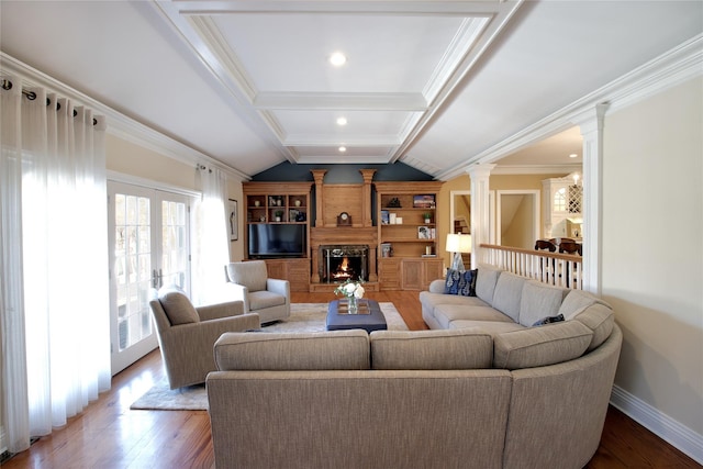 living area with a warm lit fireplace, vaulted ceiling with beams, hardwood / wood-style floors, and ornate columns