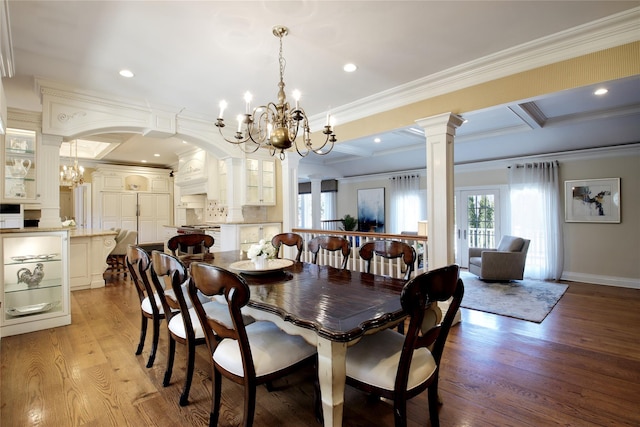 dining area with a chandelier, crown molding, and light wood-style flooring