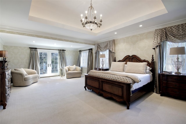 carpeted bedroom featuring french doors, a tray ceiling, multiple windows, and wallpapered walls