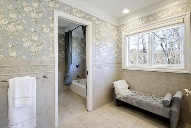 bathroom featuring a wainscoted wall, tile walls, and wallpapered walls