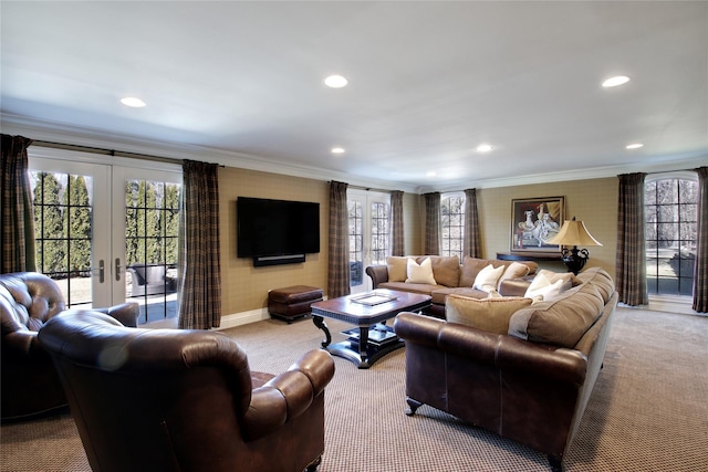 carpeted living room featuring plenty of natural light, french doors, and crown molding