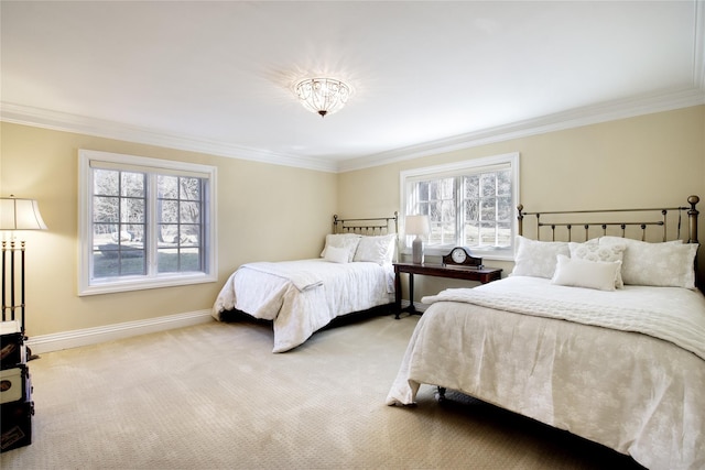 bedroom with light colored carpet, crown molding, and baseboards