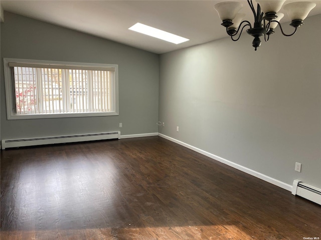 spare room featuring lofted ceiling with skylight, a baseboard radiator, a chandelier, and dark wood finished floors