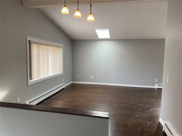 empty room featuring lofted ceiling with skylight, a baseboard radiator, and baseboards