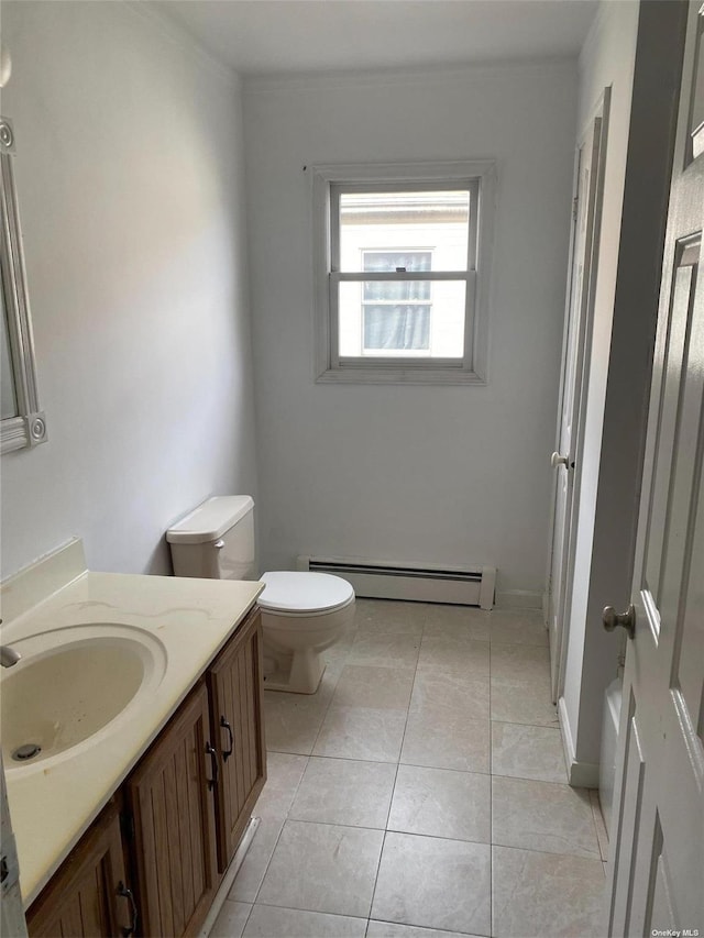 bathroom featuring tile patterned flooring, toilet, vanity, baseboards, and baseboard heating