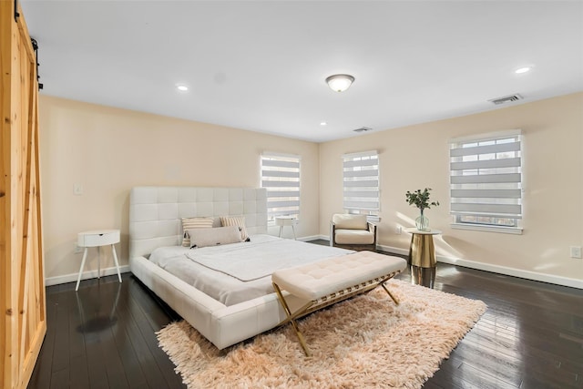 bedroom featuring dark wood-type flooring, recessed lighting, visible vents, and baseboards