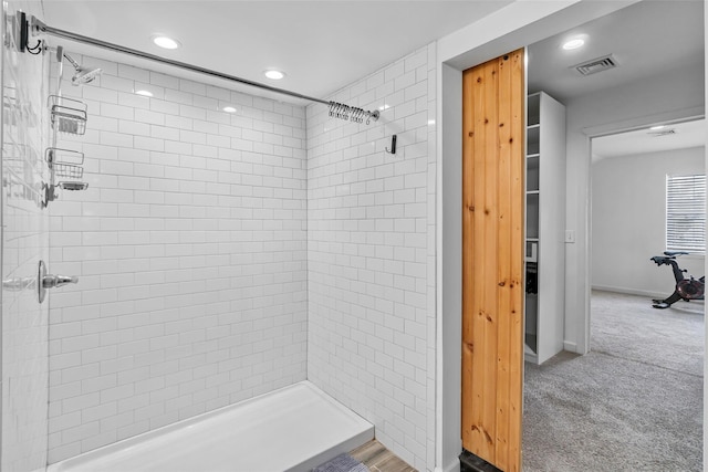 bathroom with a stall shower, visible vents, and recessed lighting