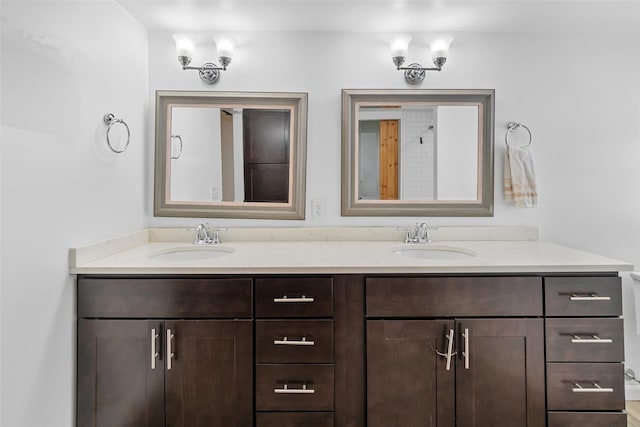 full bathroom featuring double vanity and a sink