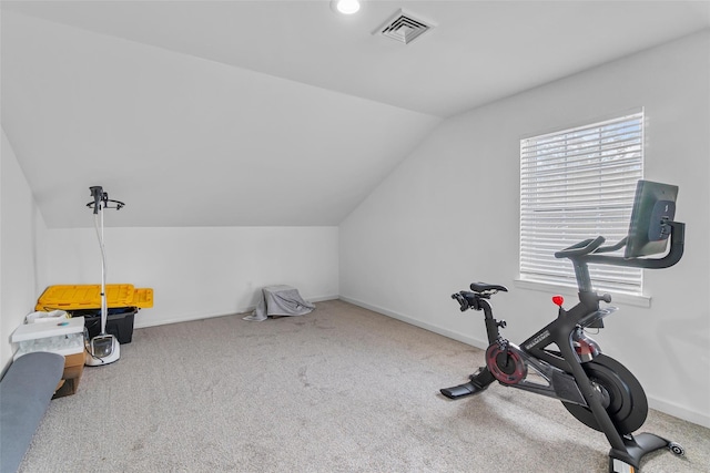 exercise area featuring carpet floors, visible vents, a healthy amount of sunlight, vaulted ceiling, and baseboards