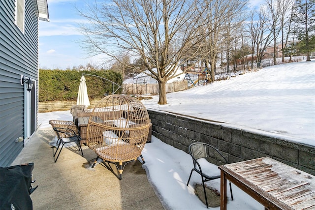 snow covered patio featuring outdoor dining space