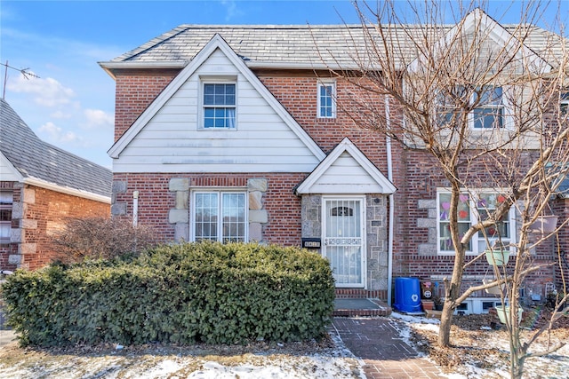 view of front of house featuring a high end roof and brick siding