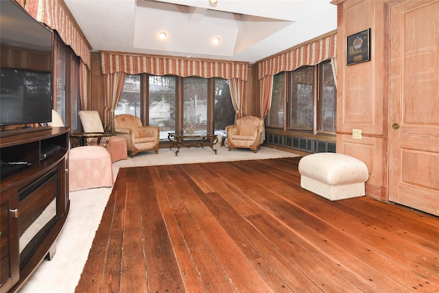 unfurnished room with radiator, a tray ceiling, and hardwood / wood-style floors