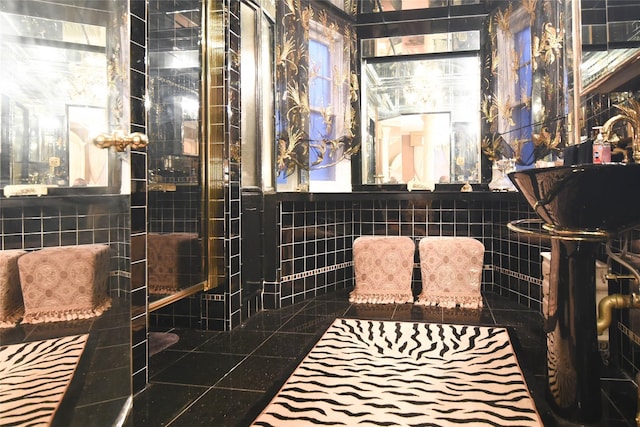 bathroom with tile walls and tile patterned floors